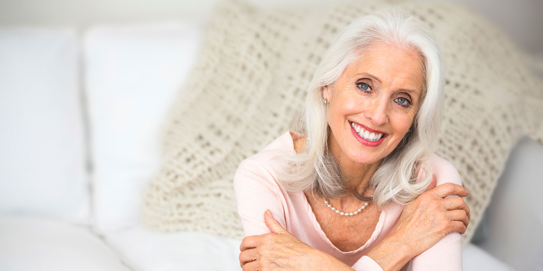 Older Woman in white smiling